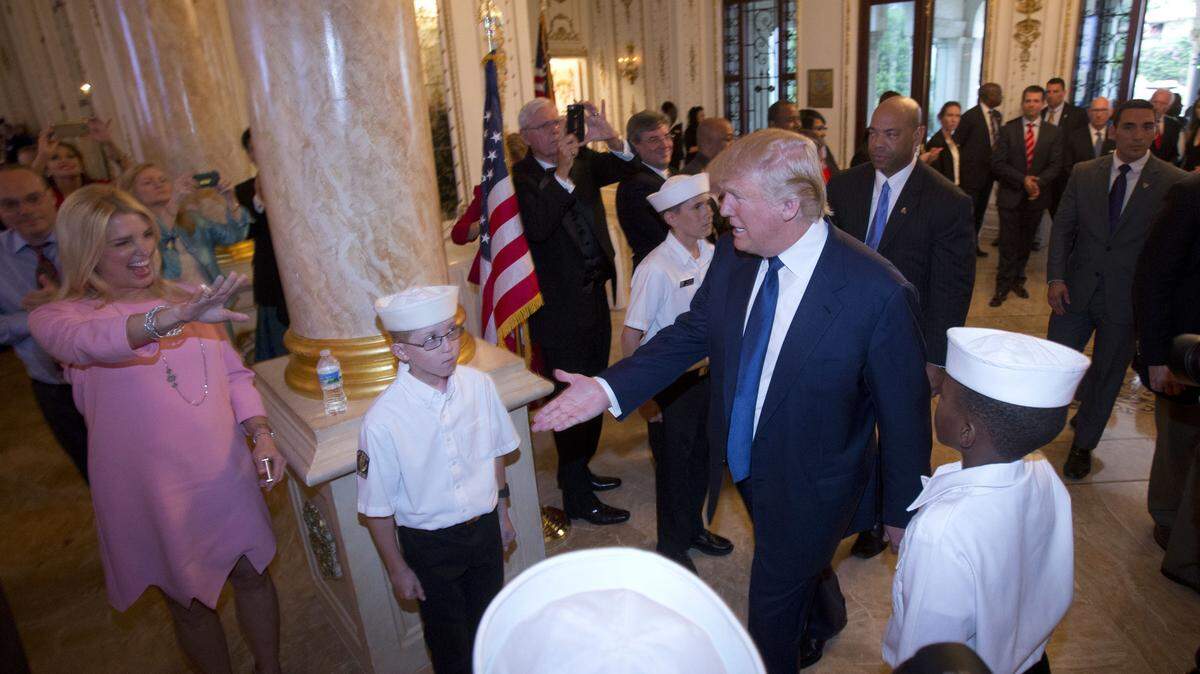 Republican presidential candidate Donald Trump, center, is greeted by Attorney General of Florida Pam Bondi, left, as he arrives at the Palm Beach County GOP Lincoln Day Dinner at the Mar-A-Lago Club, Sunday in Palm Beach. WILFREDO LEE/AP Photo