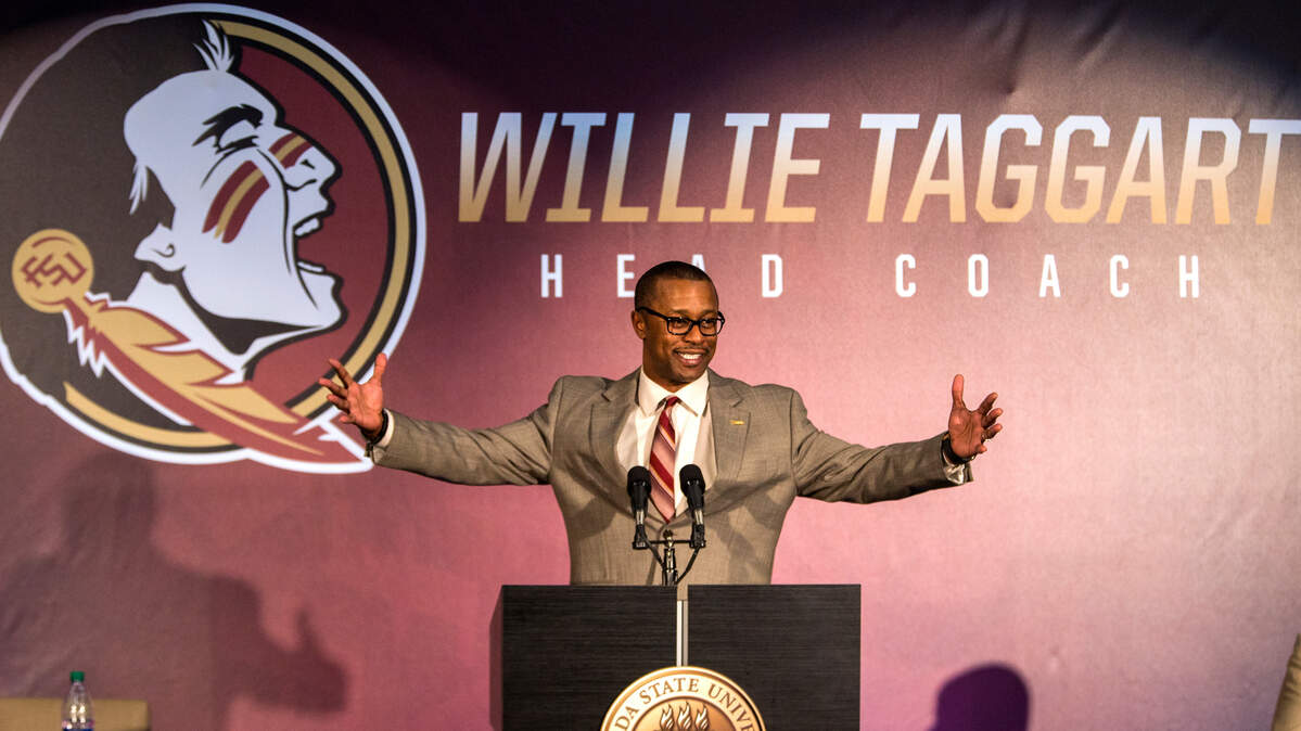 FILE - In this Dec. 6, 2017, file photo, Willie Taggart gestures as he is introduced as Florida State's new football coach during an NCAA college football news conference in Tallahassee, Fla. Taggart, the conference's only new coach in 2018, is taking over for Jimbo Fisher at Florida State and one of his first moves was to reconnect the Seminoles’ tradition-rich past with their present _ even bringing back Bobby Bowden for the spring game.