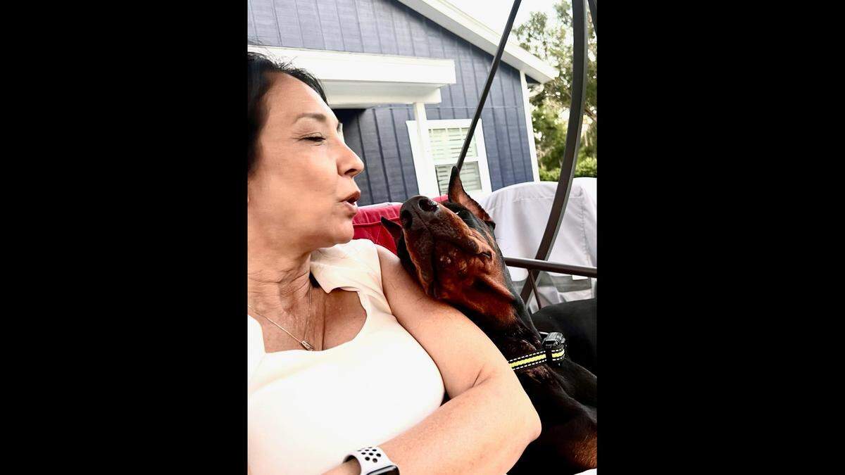 Christine Evans poses for a picture with Stella, an 18-month-old Doberman Pinscher that died while under the care of Euro Pros K-9 Center, according to the sheriff’s office.