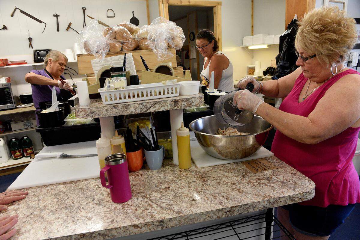 Employees at JP’s Sandwich Shop in downtown Parrish prepare food for the lunch crowd. Owner Teresa Giles said business is very brisk these days due to growth and development in the area.
