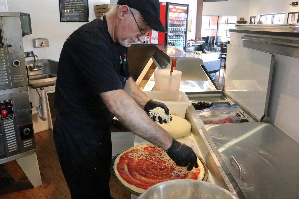 The pizzas at Adolfo’s Italian Market and Pizzeria, 8225 Natures Way, Lakewood Ranch, are hand-tossed. Benny Scotto is shown Feb. 24, 2023, making a pie.