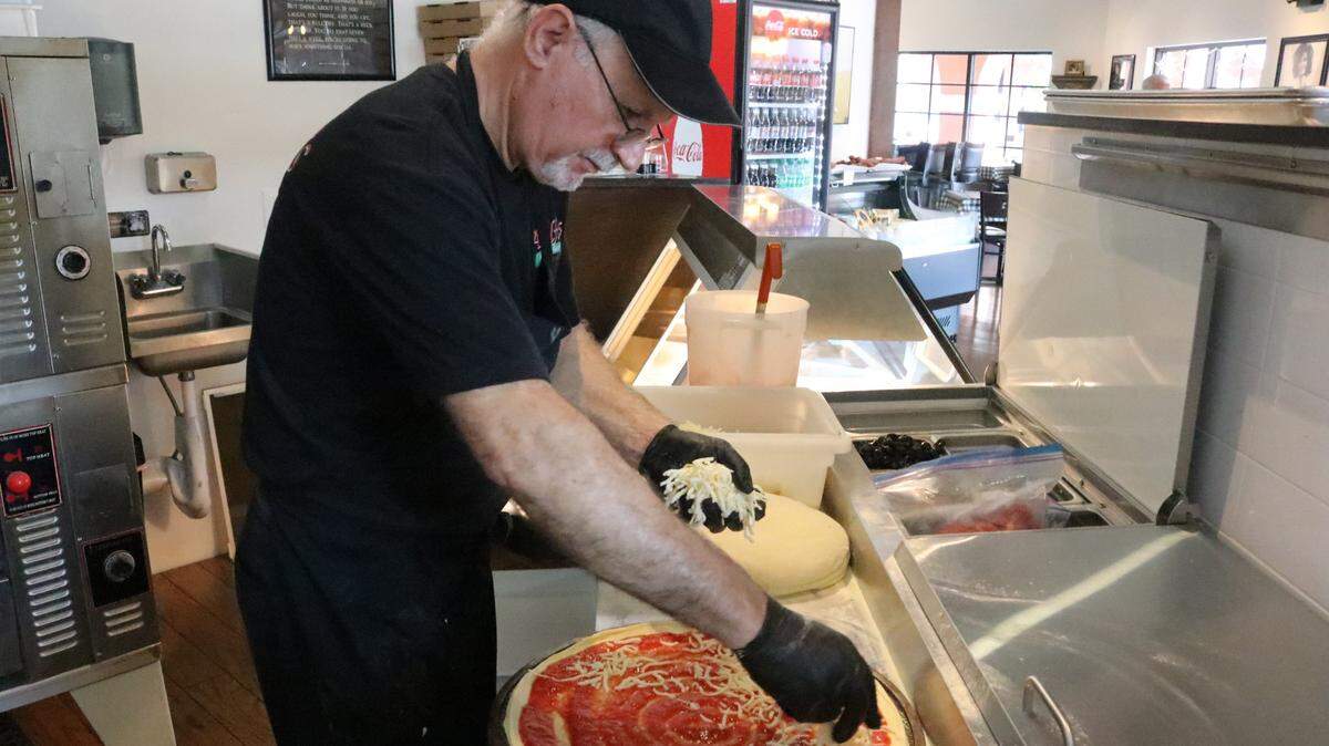 The pizzas at Adolfo’s Italian Market and Pizzeria, 8225 Natures Way, Lakewood Ranch, are hand-tossed. Benny Scotto is shown Feb. 24, 2023, making a pie.