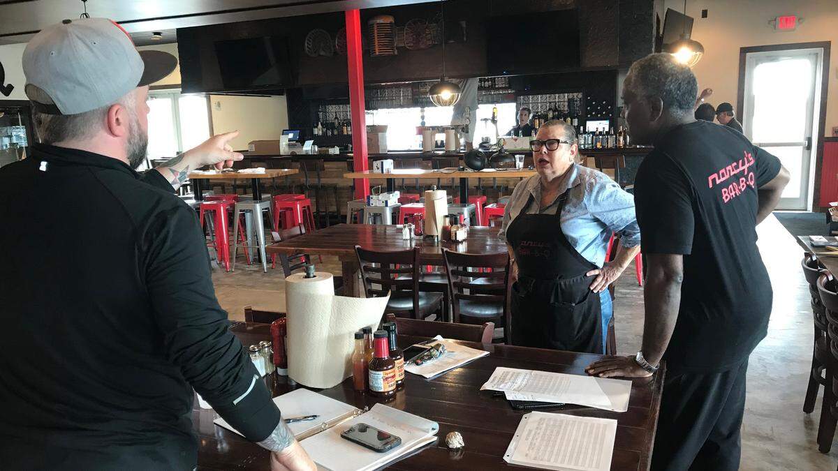 Nancy Krohngold huddles with some of her staff as preparations continue for opening Nancy’s Bar-B-Q 11 a.m. Monday in new space at 14475 State Road 70 E., Lakewood Ranch.