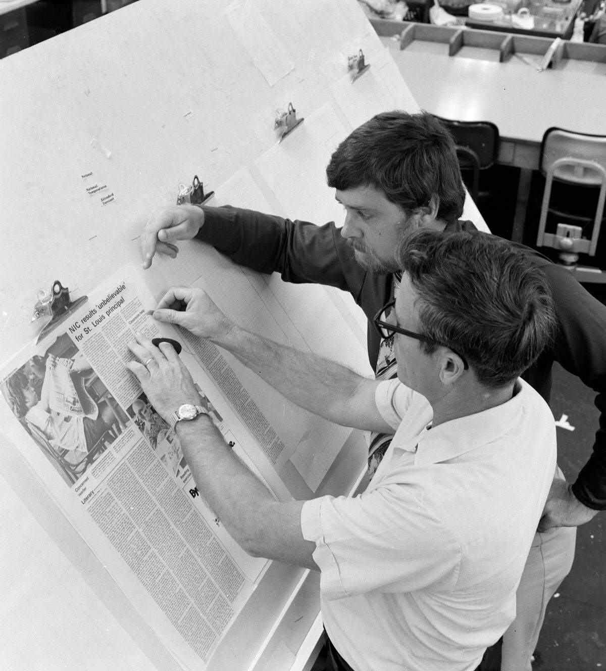 Bradenton Herald employees check the type and layout of a page before publication, 1979.