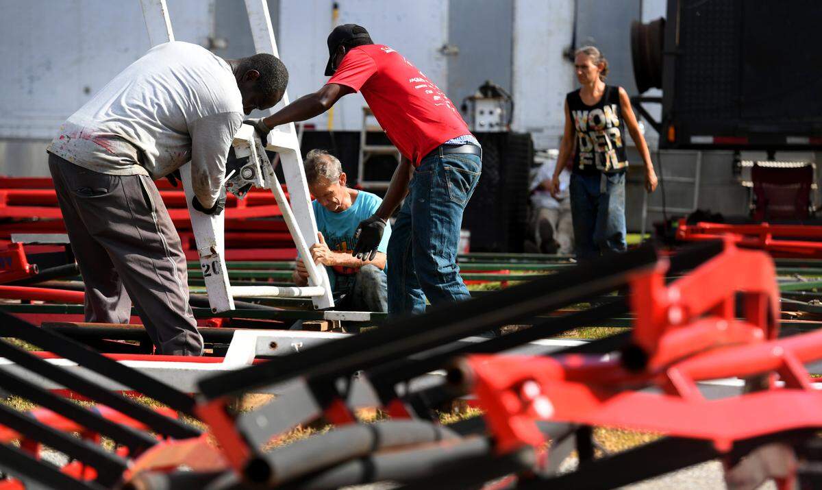 01/10/22—A crew works to assemble a roller coaster on the midway at the Manatee County Fair. The Manatee County Fairgrounds are located in Palmetto, the fair runs Jan. 13-23.