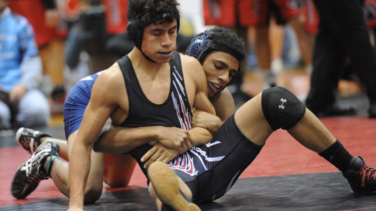 Palmetto High's Kevin Schneider wrestles North Port High's Josh Patterson in a match Saturday during the 10th annual Tiger Duals wrestling tournament. GRANT JEFFERIES/Bradenton Herald