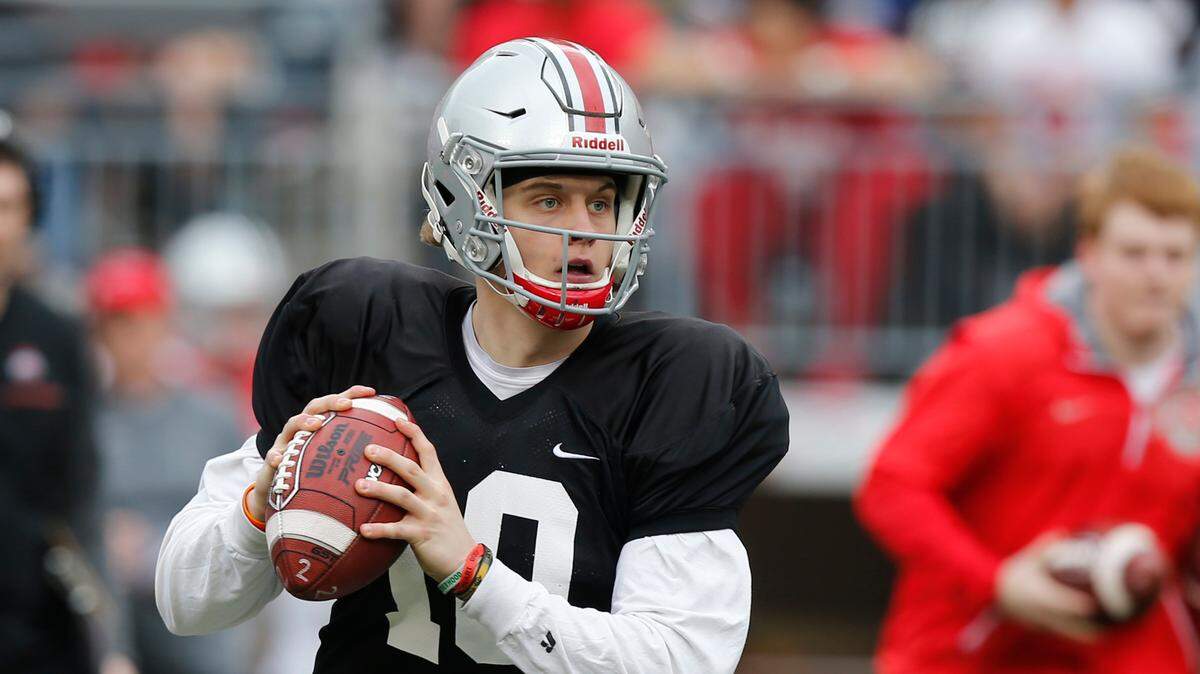 FILE - In this April 14, 2018, file photo, Ohio State quarterback Joe Burrow drops back to pass during their NCAA college spring football game in Columbus, Ohio. Burrow was J.T. Barrett’s backup in 2016 but was displaced by Haskins last year after he broke his hand in preseason camp.