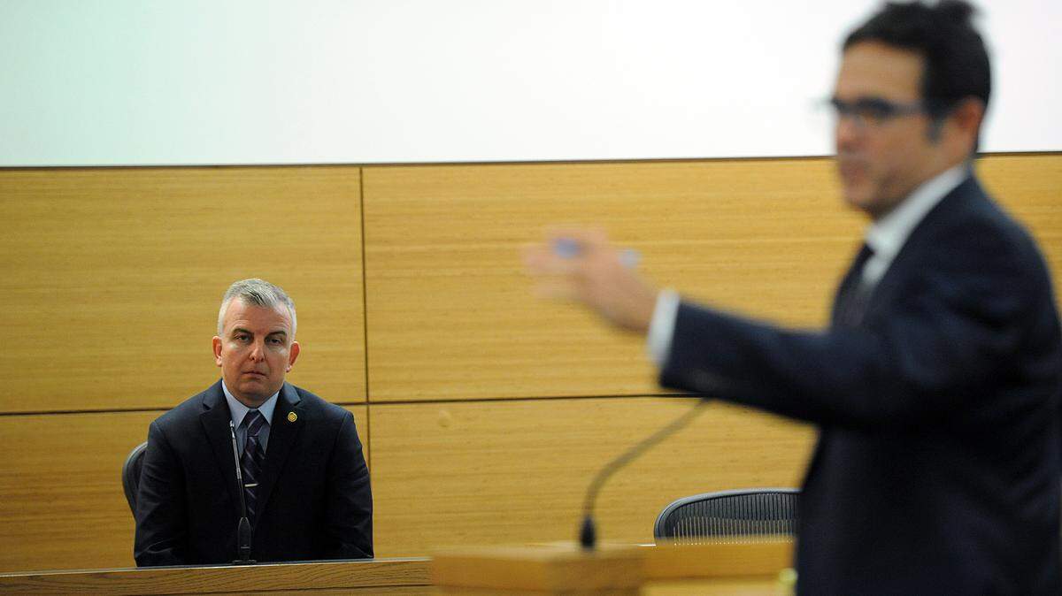 Former Bradenton deputy police chief Warren Merriman listens to his attorney, Brett McIntosh, as he takes the witness stand Tuesday during his trial for theft. Merriman, 44, is charged with two counts of misdemeanor petit theft. 
 TIFFANY TOMPKINS/Bradenton Herald