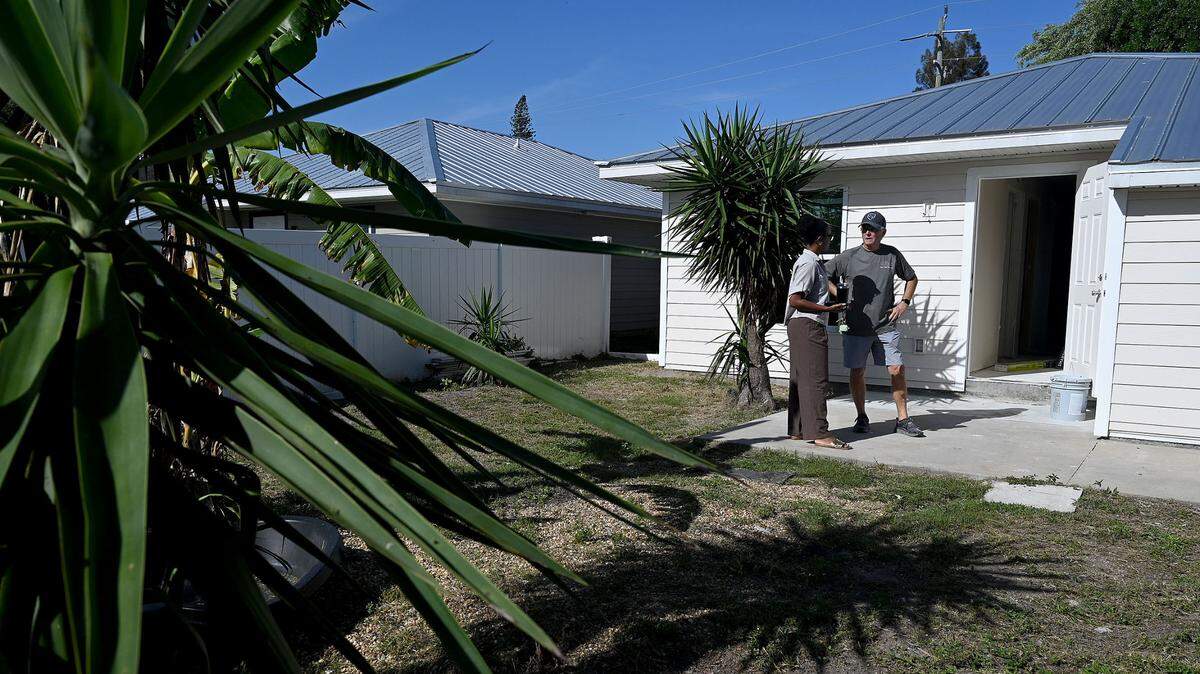 Micah-Simone Durrant of Manatee County Habitat for Humanity and Greg Kisela, President and CEO of Our Next Mission in back yard of a home in Palmetto that is being remodeled to house a veteran.