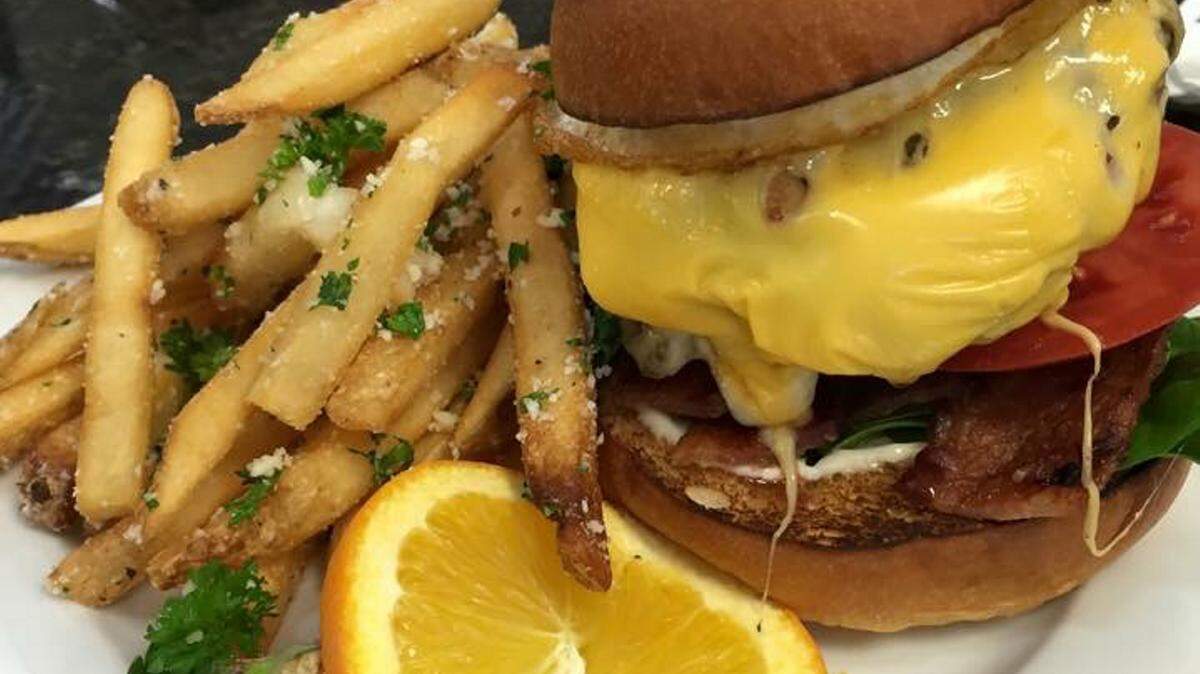 Scrambled, a breakfast and lunch restaurant in Lakewood Ranch, plans to expand its menu in January and offer dinner. Pictured is the Scrambled burger, with spinach, Capicola ham, gouda cheese and tomato served on a brioche bun with French fries tossed in herbs and parmesan. PROVIDED PHOTO