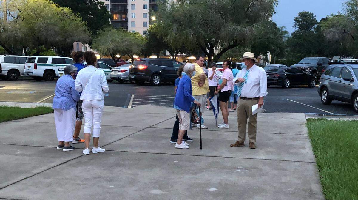 9/1/2021--A portion of the crowd of several hundred who attended a meeting at the parish office of St. Joseph Catholic Church pause before getting into their cars to chat after the meeting concluded at 7:45 p.m. Wednesday.