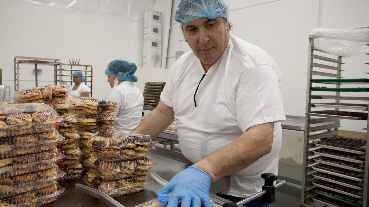 Francesco Mucci, founder of Bombolo Biscotti, works the packaging line in the new, 30,000-square foot space he moved his commercial bakery into in the Whitfield area in January. MATT M. JOHNSON/Bradenton Herald