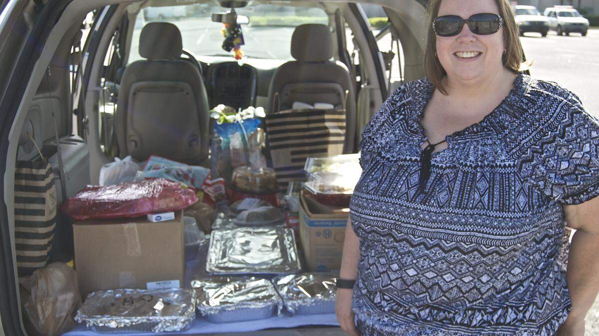 State College of Florida, Manatee-Sarasota (SCF) Disability Resource Center (DRC) Support Specialist Susan French prepares to deliver a complete Thanksgiving feast donated by the SCF DRCs and other friends and colleagues to Hope Family Services, which provides refuge for victims of domestic violence. PHOTO PROVIDED