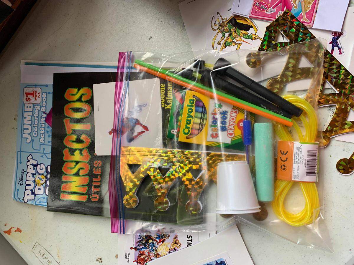 Bags for children of traveling immigrant families made up by Caridad Sarabia Ramos Cisneros included homemade activity books, coloring supplies and small toys.