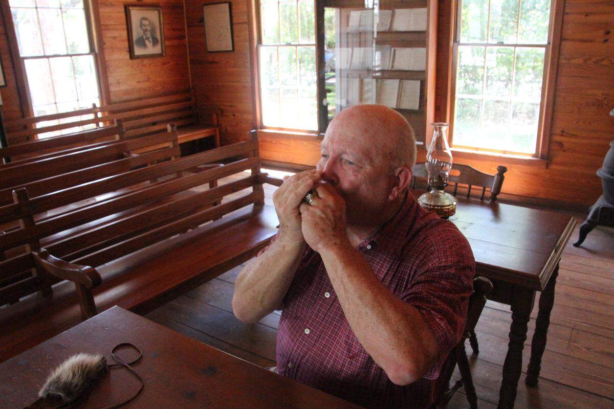 Erwin Wunderlich plays a Civil War-era tune on harmonica. He will share his knowledge with children at a pair of workshops on July 14 at Manatee Village Historical Park.