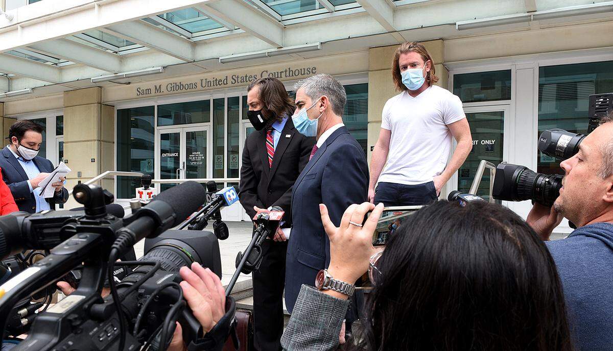 FILE: 01/11/20--Adam Johnson, right, emerges from the Tampa Federal Courthouse with attorneys after a first appearance on charges stemming from the riot on the Capitol on January 6.