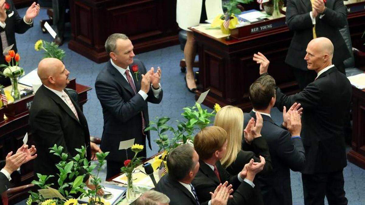 Florida Gov. Rick Scott, right, waves as he is recognized by the House of Representatives at the start of the legislative session, Tuesday, Jan.12, 2016, in Tallahassee. Steve Cannon AP