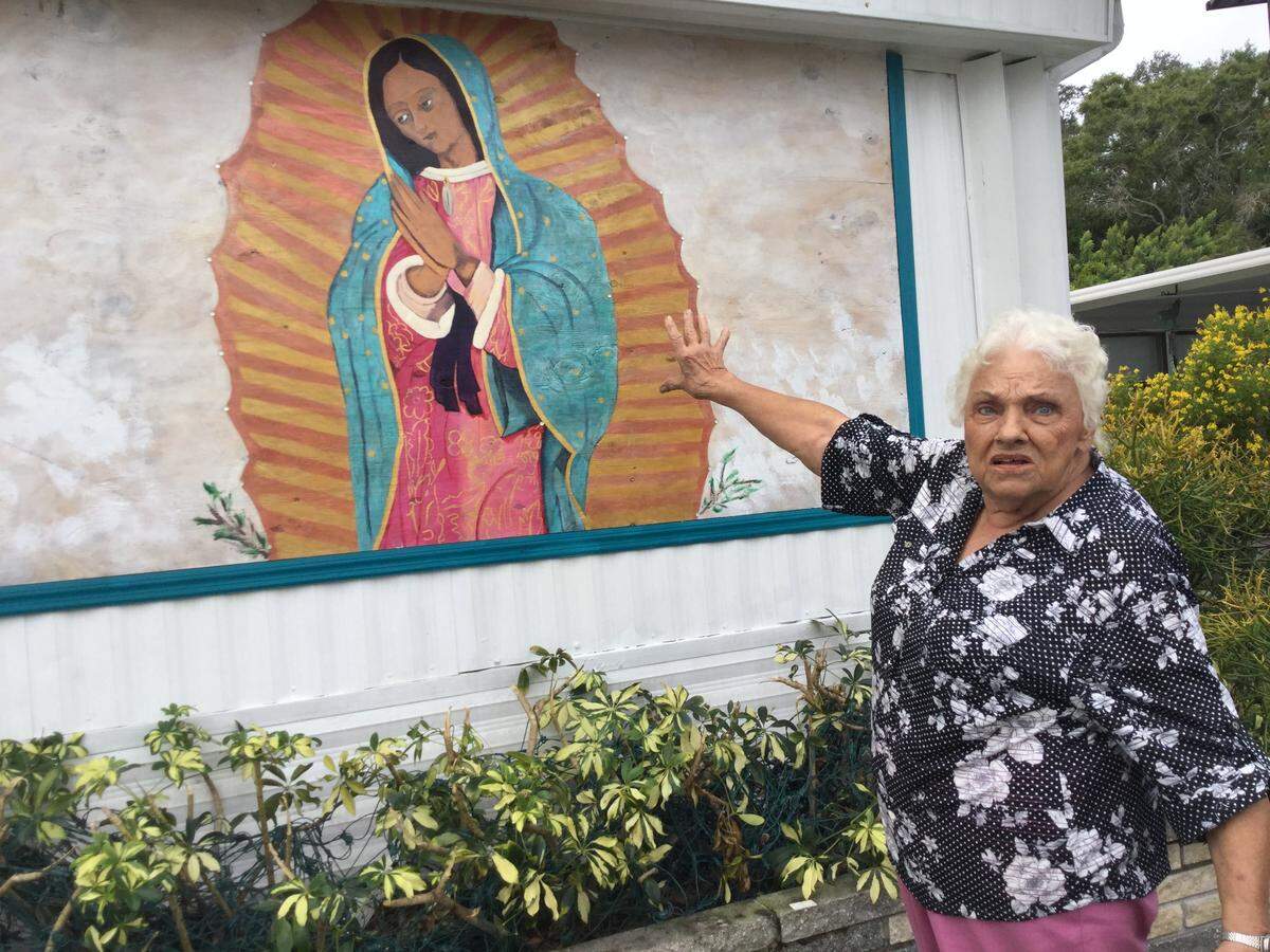 Attorneys representing Tropical Palms mobile home park in Bradenton are following through with a threat of legal action if resident Millie Francis continues to refuse to remove a painting of the Virgin Mary in front of her mobile home.