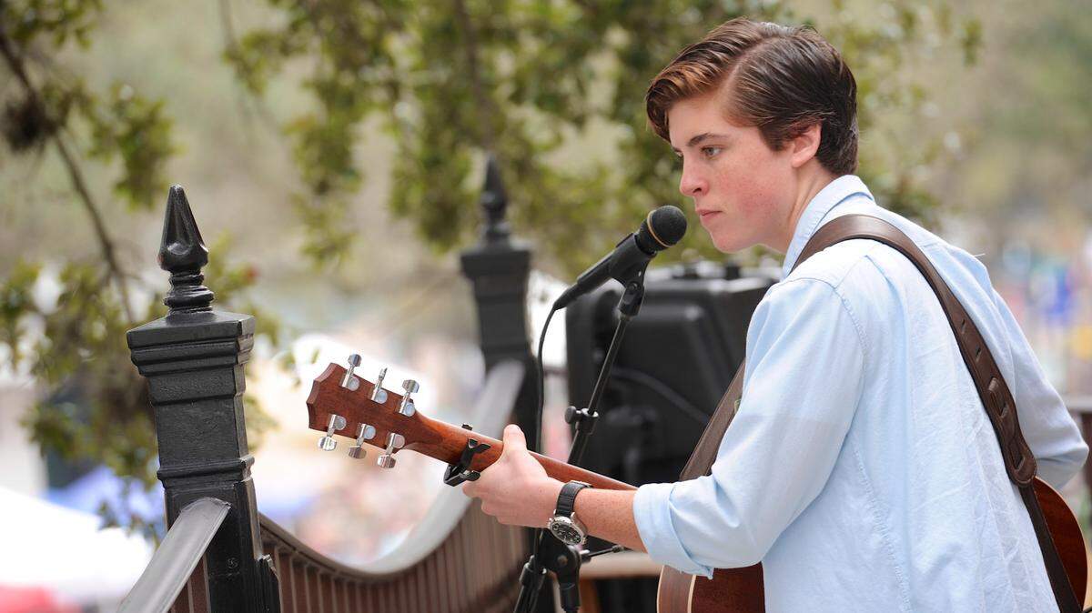 Former American Idol contestant Sam Woolf performs from a balcony overlooking Old Main Street during the Bradenton Farmers' Market in 2014. 
 File Photo