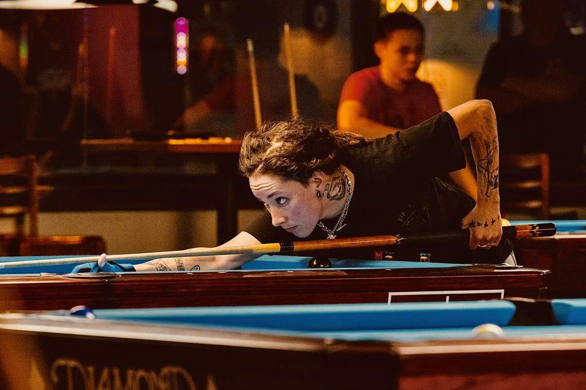 Manatee County’s Taylor Marlow lines up a shot in preparation for the World Billiards Championship in Las Vegas, which starts Thursday, August 8, 2024. Marlow is competing with her Manasota APA team called the Young Guns.