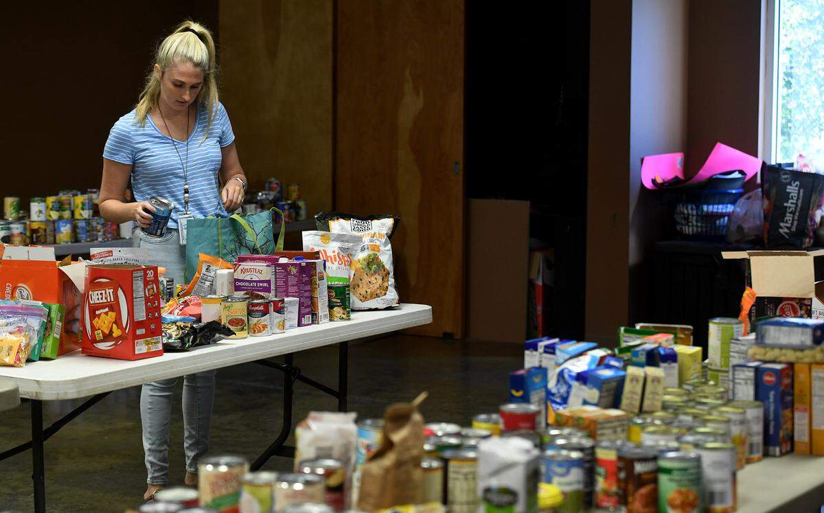 Kristen Weems, a 3rd grade teacher at Myakka Elementary School, organizes supplies for families impacted by Hurricane Ian at the Myakka Community Center October 7, 2022.