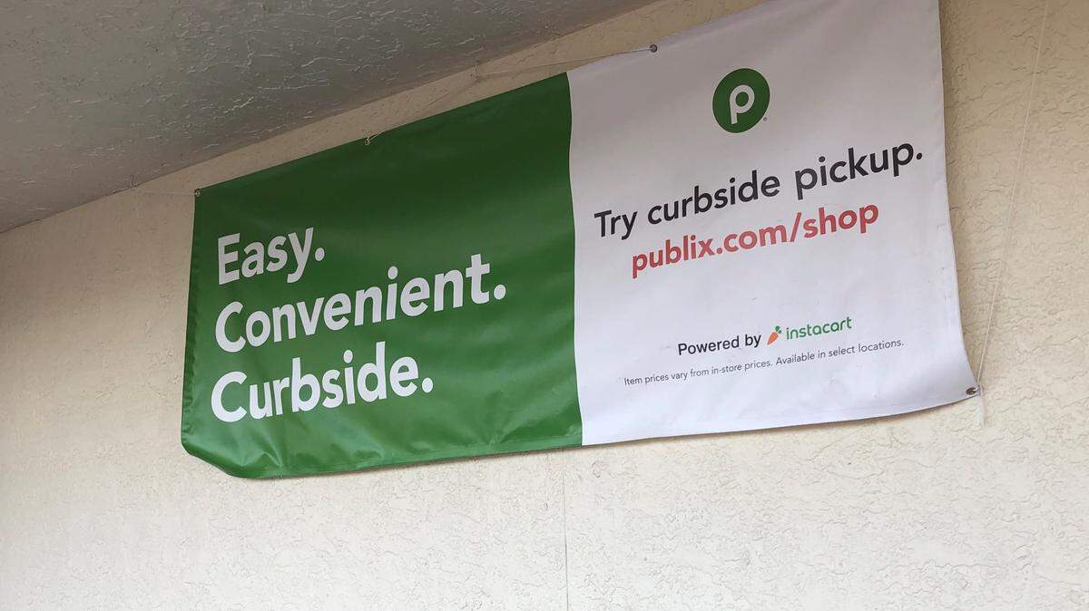 A banner at Publix advertises curbside pickup via Instacart, an online ordering service serving many groceries.