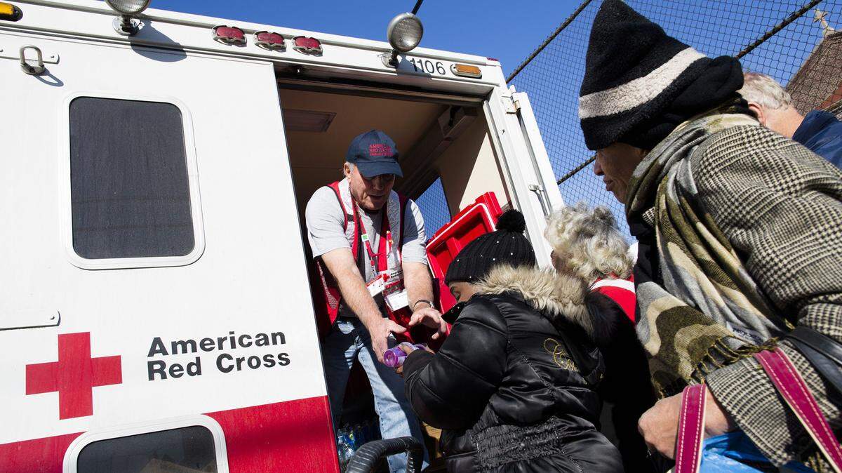 A member of the American Red Cross distributes food to residents of Coney Island affected by Superstorm Sandy in 2012 in the Brooklyn borough of New York. A year after receiving huge sums to respond to Superstorm Sandy, the American Red Cross experienced a 32 percent drop in charitable donations in 2014. AP Photo File