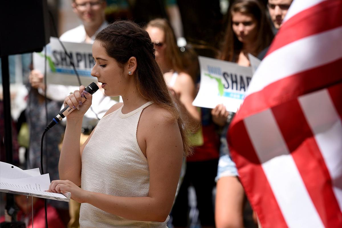 Julia Dortch, 15, speaks before Gabby Giffords, former Arizona congresswoman and gun control advocate after being a victim of gun violence, addresses a group at Sarasota's Five Points Park Thursday.