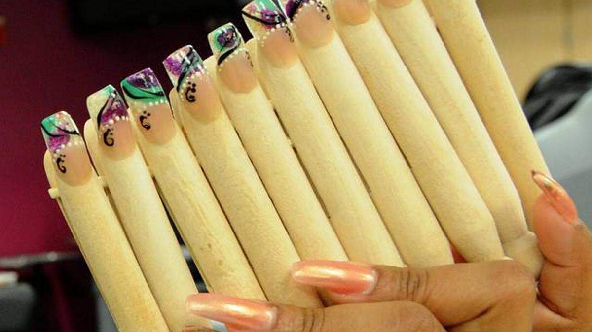 Manatee Technical College graduate Milena Cervantes, 36, holds some of her nail creations in this Herald file photo.GRANT JEFFERIES/Bradenton Herald
