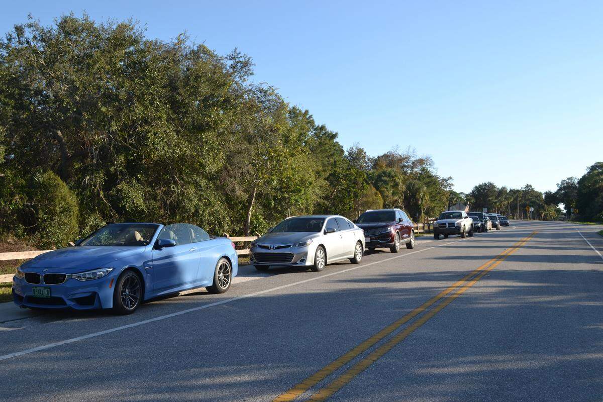 Cars line 75th Street Northwest outside of De Soto National Memorial, where the parking lot was closed due to a federal government shutdown.
