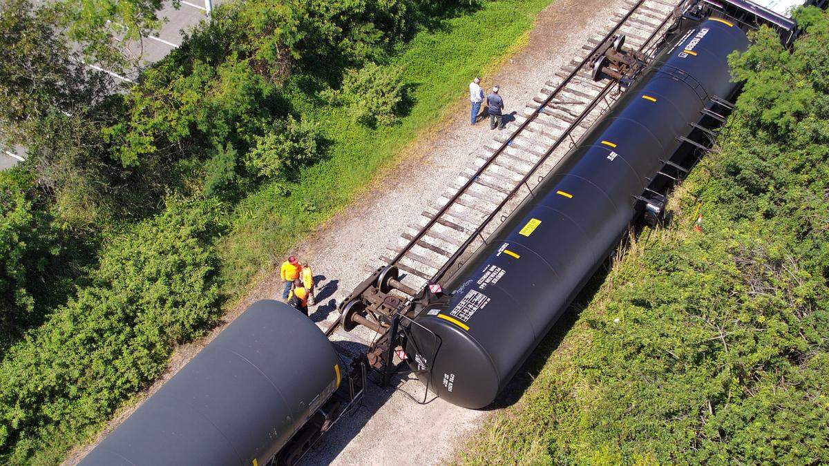 Workers inspect a Seminole Gulf Railways train that derailed in Bradenton Feb. 28, 2023.