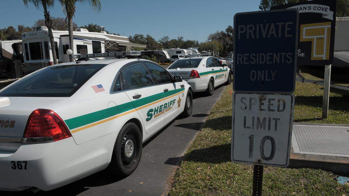 Manatee County Sheriff's Office deputies secure an area of Fisherman's Cove RV Resort on Thursday where they believe an armed man has barricaded himself after a domestic dispute. 
 GRANT JEFFERIES/Bradenton Herald