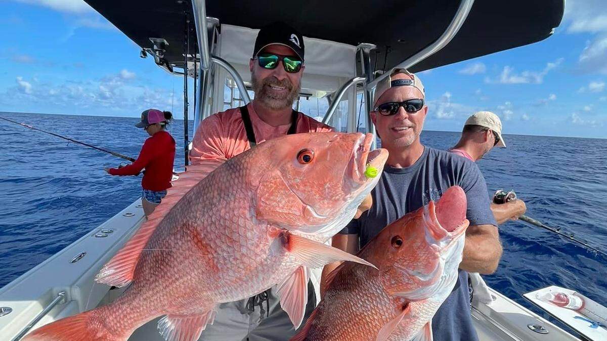Rob Chapman III and Tom Howard post with the 20- and 13-pound red snapper they landed on Sunday, July 3, 2022.