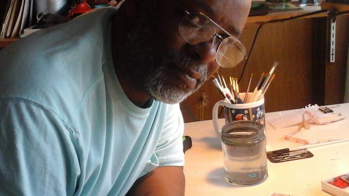 Bradenton watercolor artist Ben Love, shown here at his desk in his apartment, has painted about 60 portraits of the homeless in Manatee County. Love was homeless himself off and on for five years. Many homeless people stop by the apartment he shares with his wife, Jacki and his five-year-old son, Max, to get a sandwich, a cup of coffee and some spare change if Love has it. 
 PROVIDED PHOTO
