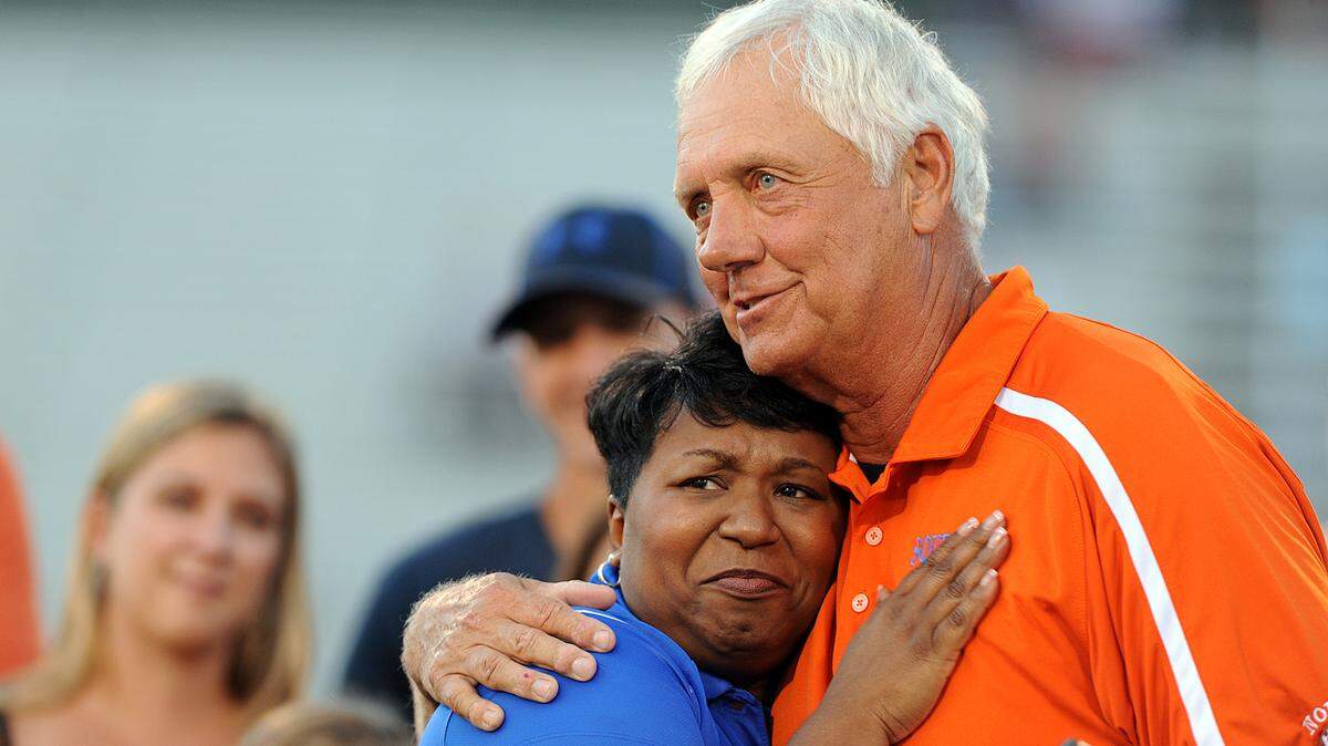 Former Southeast football coach Paul Maechtle gets a hug from Superintendent Diana Greene during a pre-game ceremony to name the field the Paul Maechtle Field at Kiker Stadium before Friday's game against Cardinal Mooney, where Maechtle is now an assistant coach. 
 TIFFANY TOMPKINS-CONDIE/Bradenton Herald