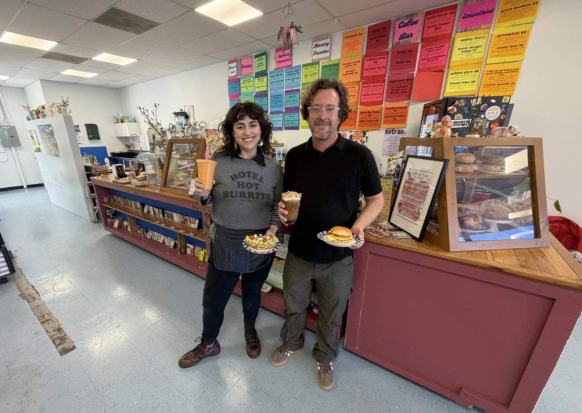 Megan Harkinson (left) is the owner-operator of Smiley Face Cafe, 923 10th St. E., Palmetto. She holds avocado toast and a Sunny Day smoothie, while husband Nick (right), who works the cafe on weekends, has the Smiley Face Sando and Cereal Killer Cold Brew.