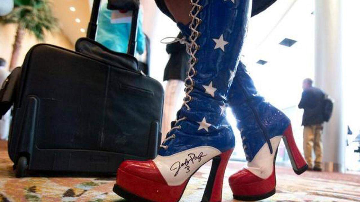 Amy Hedtke from Waxahachie, Texas, wears patriotic boots at the Republican National Committee spring meeting Thursday in Hollywood, Fla. 
 WILFREDO LEE AP