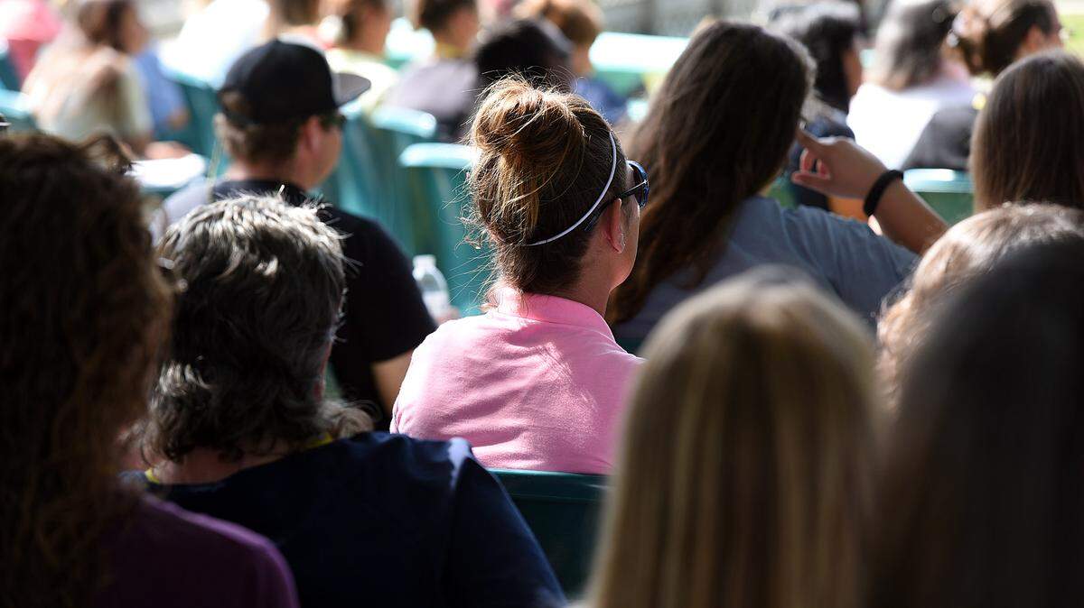 Inmates at Bradenton Bridges, a women-only transition facility, sit during a press conference to try to keep the facility's doors open after the state of Florida did not extend the contract with the facility. 
 TIFFANY TOMPKINS/Bradenton Herald