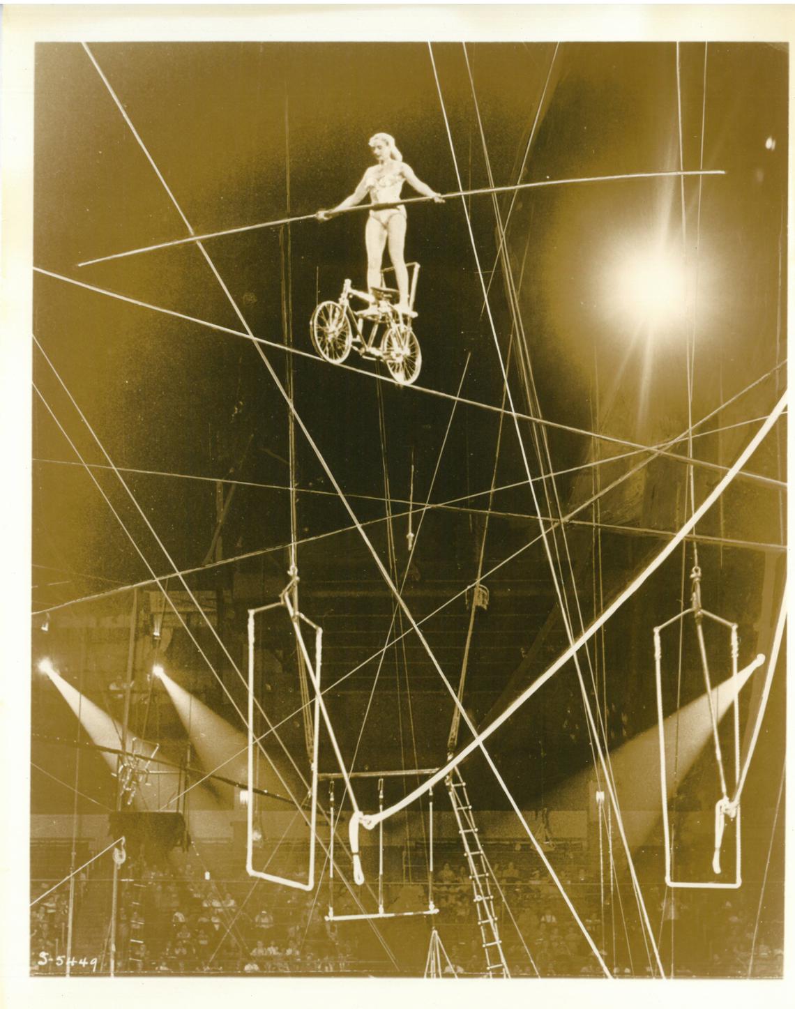 Aerialist Josephine Berosini performs on a bicycle on the high wire in 1954.