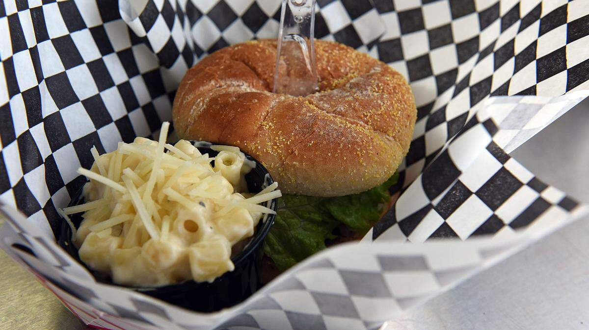 A Blue Rooster hamburger served with mac and cheese from their food truck parked in front of Darwin Brewing Co. The food truck specializes in southern comfort food. 
 TIFFANY TOMPKINS/Bradenton Herald