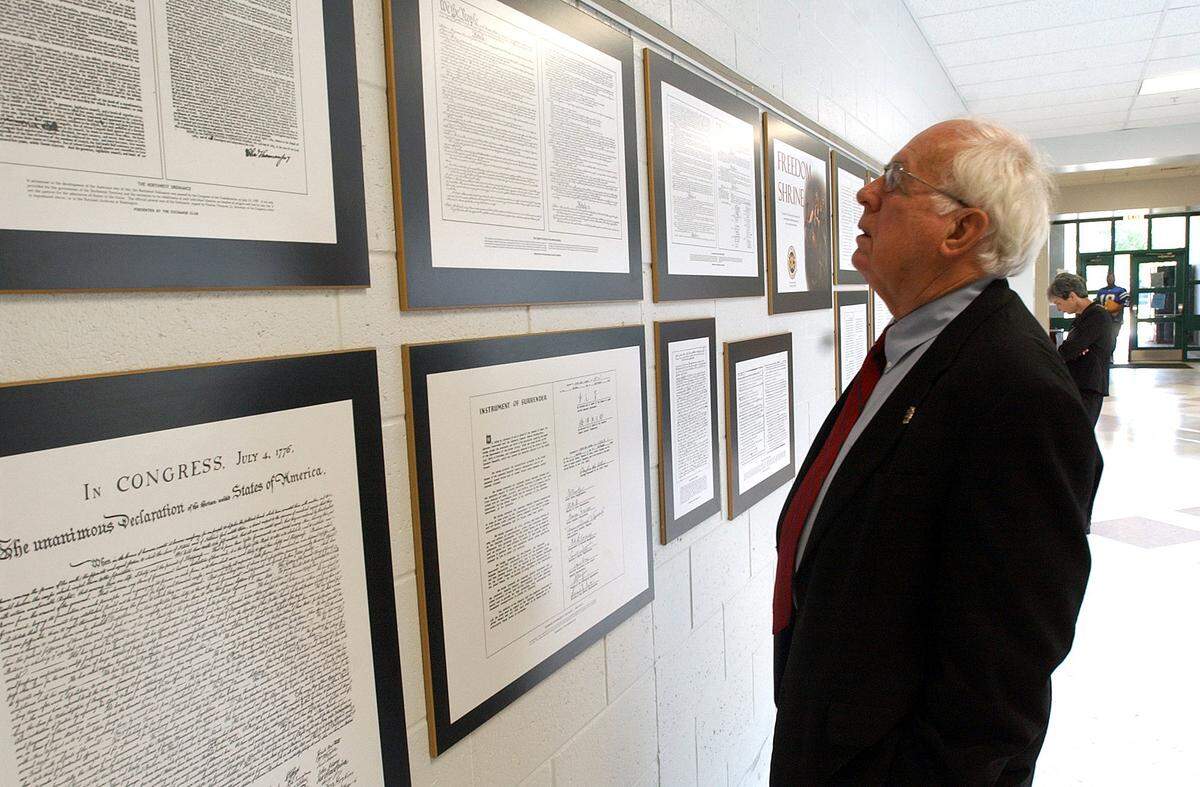 Walter Miller, then a Manatee County School Board member, looks over some of the 28 documents at the dedication of the Freedom Shrine at Lakewood Ranch High School. File photo -- 05/17/05.