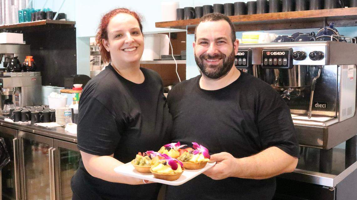 Eleanora and Luigi Raso, shown Oct. 31, 2022, hold a tray of fruit tarts at Breakfast at Victoria’s, which opened this week in Holmes Beach.
