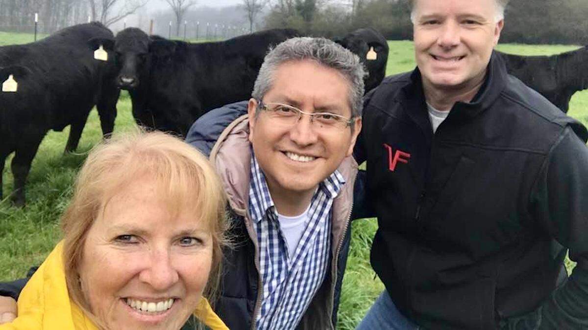 Renee Toussaint-Strickland of Parrish brokered a deal to send registered beef cattle from the United States to Peru to improve herds there. A tractor-trailer picked up the cattle in Texas, Alabama and Georgia and delivered them to Miami International Airport. She is shown above with Yobert Alvarez of Peru (middle) and Georgia rancher Lee McGarity.