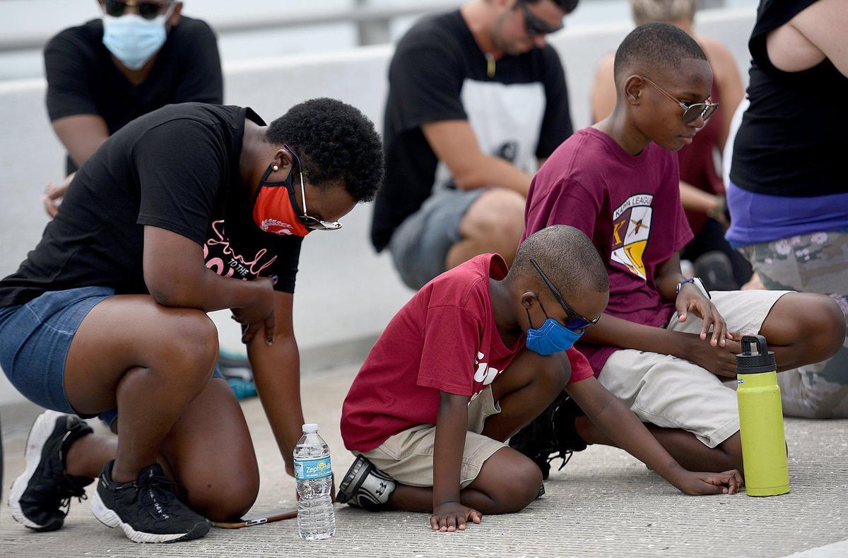 A new proclamation will label racism a public health crisis in Manatee County. The Black Lives Matter group supports the move to promote education and racial training. In this Bradenton Herald file photo, marchers take a knee at the pinnacle of the Green Bridge in remembrance of George Floyd during a One Love, One Nation unity march on June 7, 2020.