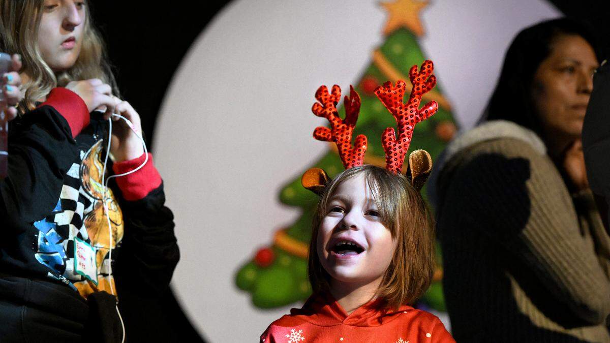 Giorgia Cramer waits in a line to see Santa at the 39th Annual Flight to the North Pole program presented by the Manatee County Sheriff’s Office, Sarasota/Bradenton Airport Fire Dept. and Feld Entertainment.