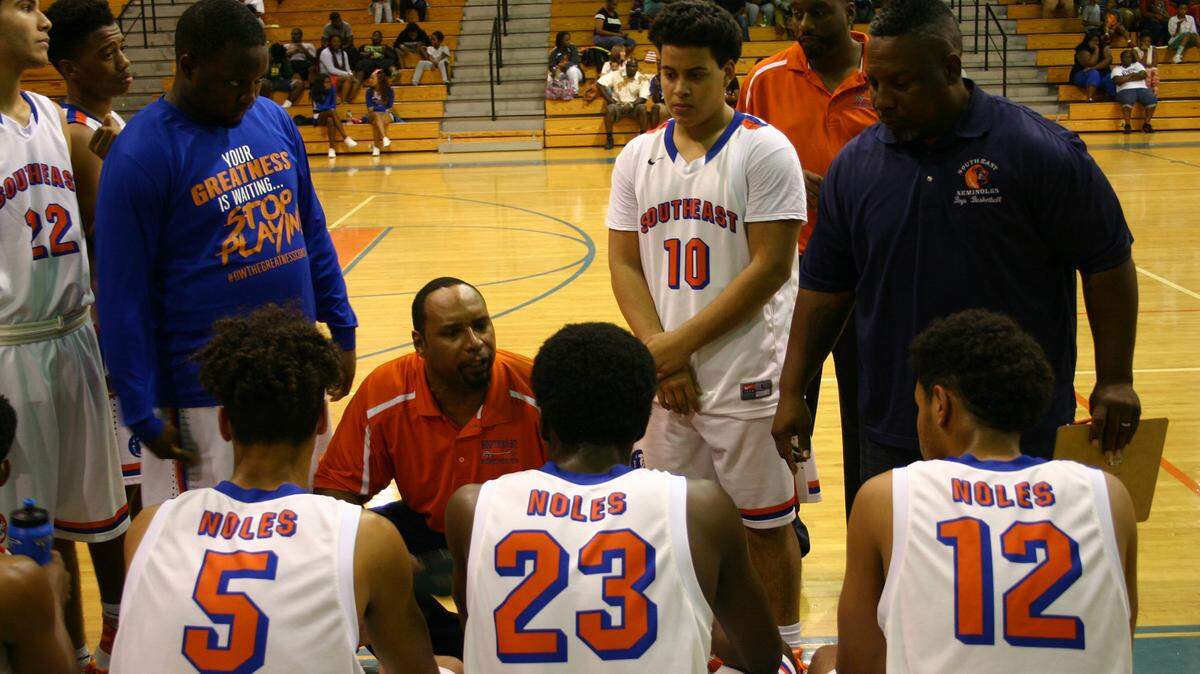 Southeast players listen to coach Floyd Watkins during a timeout Saturday against Palmetto. ALEX BARRETT/abarrett@bradenton.com