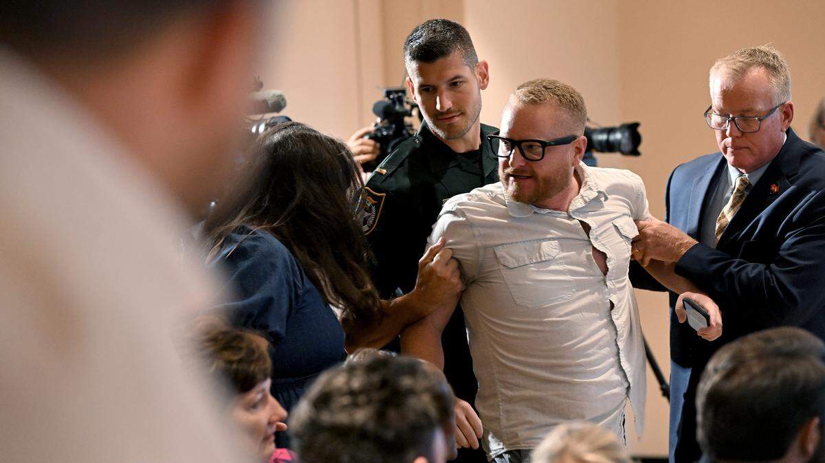 A protester disrupted a press conference while Florida Governor Ron DeSantis spoke at the Manatee Performing Arts Center in Bradenton on July 24, 2025.
