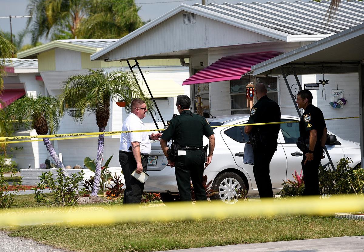 Manatee County Sheriff's detectives at the scene of a homicide in Royal Garden Estates in Bradenton. The body of a woman, later identified as Joan Demeo, was discovered in the carport.