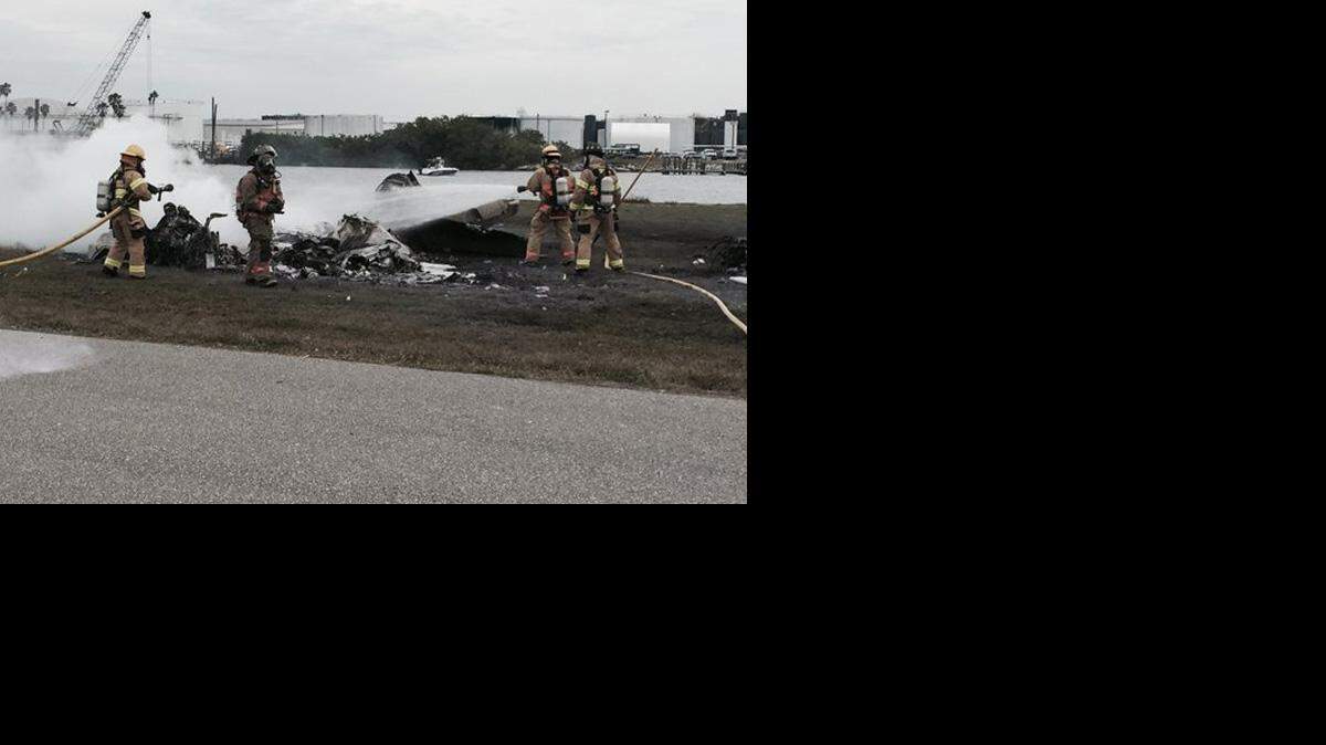 Firefighters spray the wreckage of the plane in an effort to put out the fire. Tampa Police Department photo.