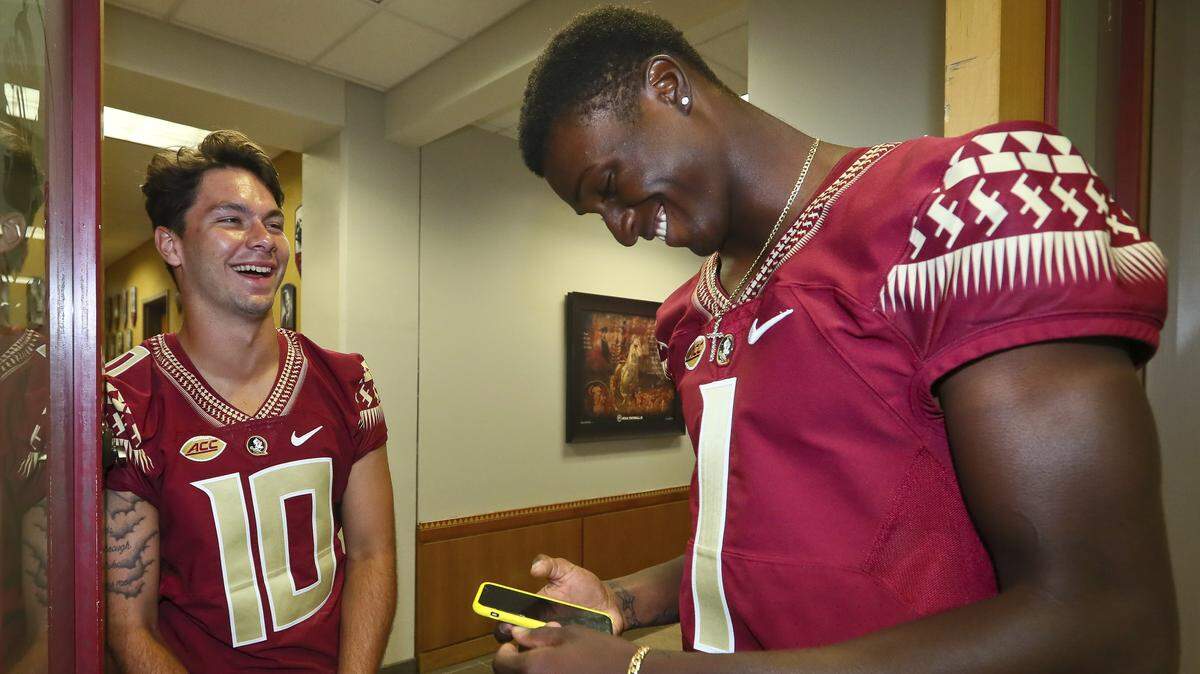 Florida State quarterbacks Bailey Hockman (10) and James Blackman (1) share a laugh after interviews concluded at the NCAA college football media day Aug. 19.